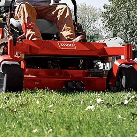 Zero-turn mower cutting a healthy green lawn