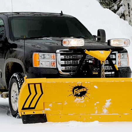 Truck with a snow plow clearing winter snow