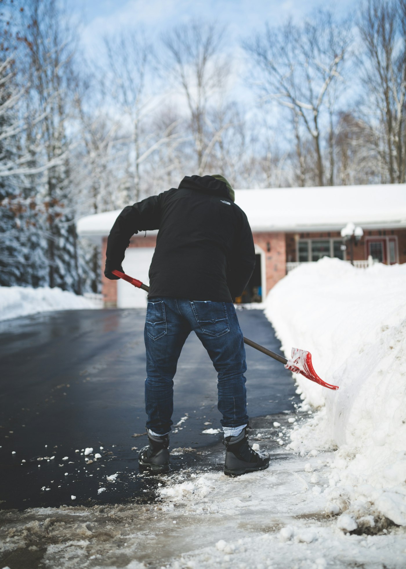 Shovelling a snow-covered driveway